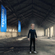 A lonely man stands in an empty warehouse with Horizon flags hanging behind him.
